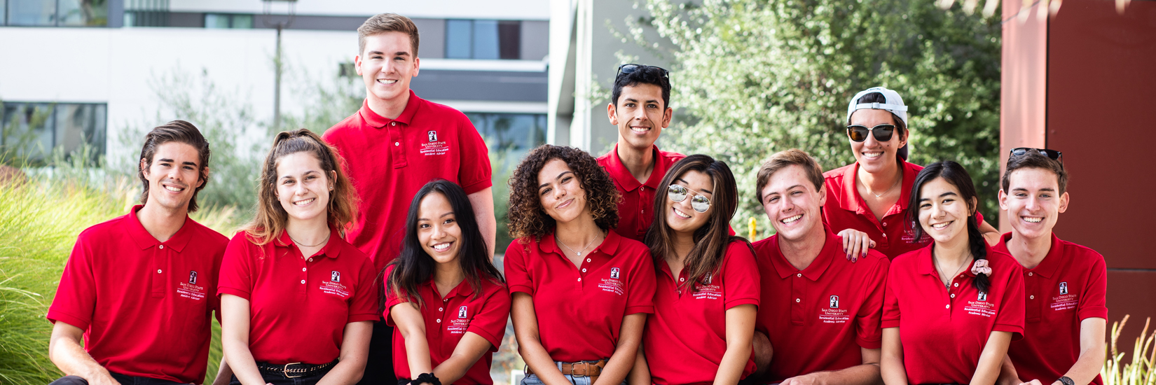 SDSU students sitting on a wall